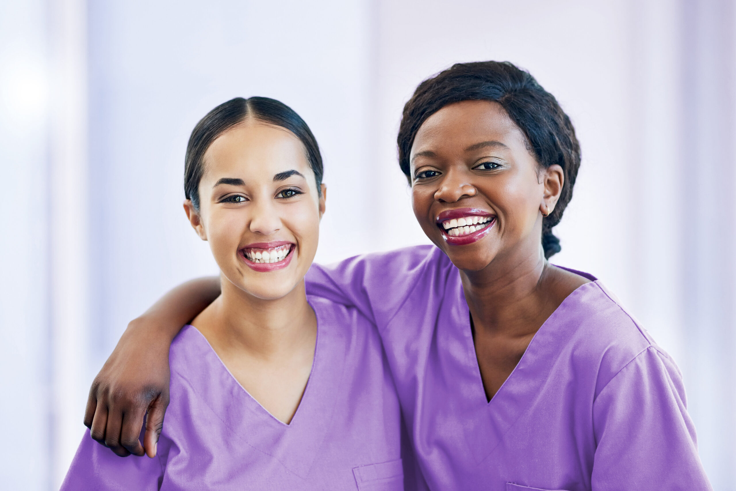 Two female medical employees with their arms around each other